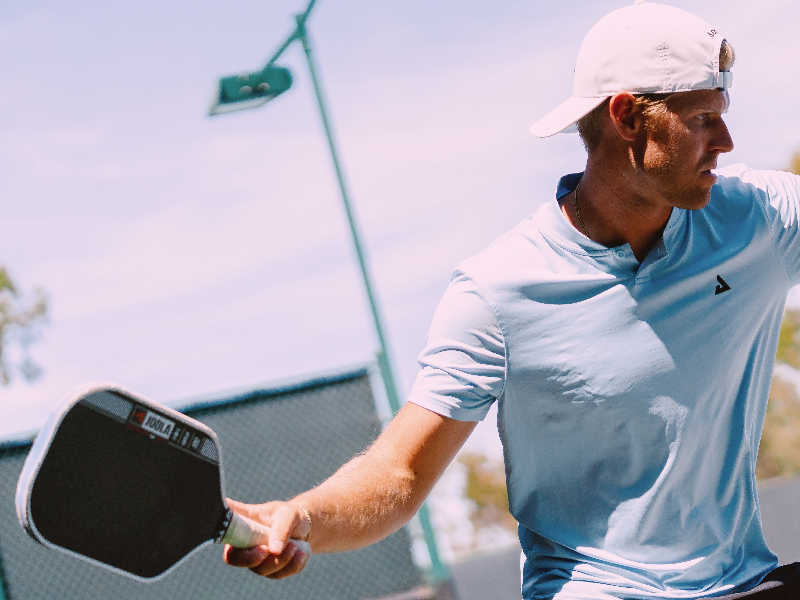 Connor playing pickleball or tennis
