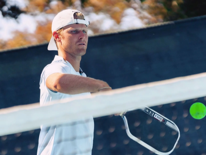 Connor playing pickleball or tennis